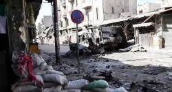 800px-Bombed_out_vehicles_Aleppo