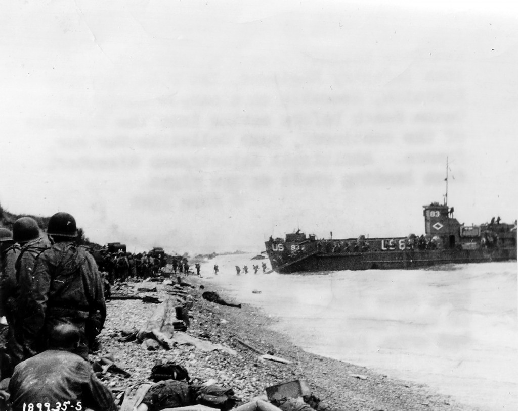 U.S. assault troops of the 3d Battalion, 16th Infantry Regiment, 1st U.S. Infantry Division, assemble on a narrow strip at Omaha Beach. (June 6, 1944). Source: U.S. National Archives, # SC-189935.