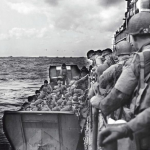 Men of the 359th Infantry Regiment, 90th Infantry Division transfer from LCI(L)-326 to a waiting Higgins Boat on the afternoon of D-Day. Source: U.S. National Archives, # 26-G-2408.