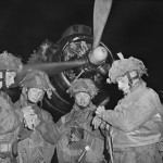 Operation Tonga. 4 'stick' commanders of 22nd Independent Parachute Company, British 6th Airborne Division, synchronize their watches at about 11 p.m. prior to take off from RAF Harwell, Oxfordshire. Officers, left to right: Bobby de la Tour, Don Wells, John Vischer, Bob Midwood. (June 5, 1944). Source: Imperial War Museums,  H 39070.
