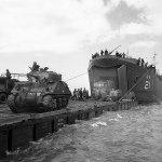 USS LST-21 unloads British tanks and trucks off Normandy. (June 6, 1944). Source: U.S. National Archives, # 26-G-2370.