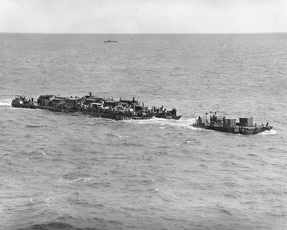"Rhino" ferry and tug approaches the Normandy shore. (June 6, 1944). Source: U.S. National Archives, # 26-G-2335.
