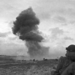 Nazi 88mm guns pound Utah Beach as American troops push into Normandy, France. (June 11, 1944).  Source: U.S. National Archives, # 111-SC-190109.