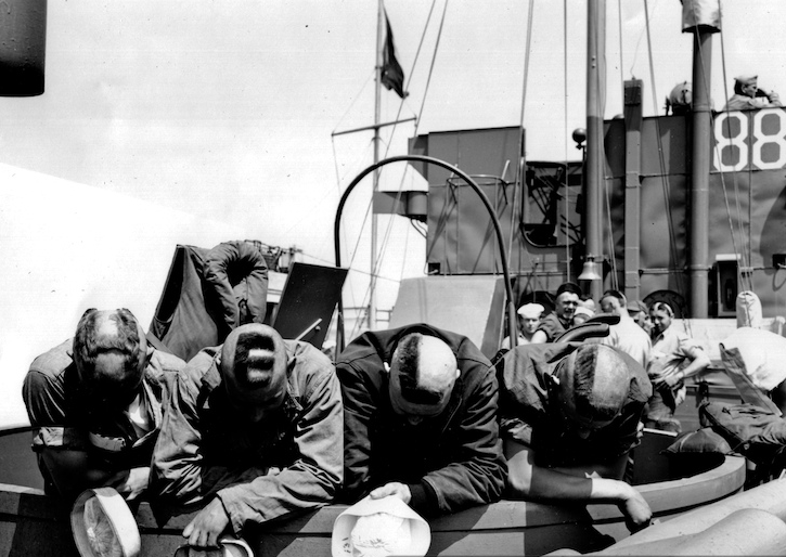 4 Coast Guardsmen, proceeding as scouts in an LCM to the French invasion beach shortly before H-hour, get their heads together and display their full accord with General Sherman on the subject of war ("War is hell"). Source: U.S. National Archives, # 26-G-2410.