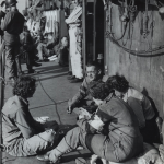 Army nurses spanning the English Channel play a game of bridge aboard a Coast Guard-manned infantry landing craft. Source: U.S. National Archives, # 26-G-2605.