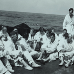 Wounded German prisoners follow doctor's orders and get plenty of fresh air attired in robes and slippers provided for them aboard a Coast Guard-manned transport carrying them to the U.S. Source: U.S. National Archives, # 26-G-2587.