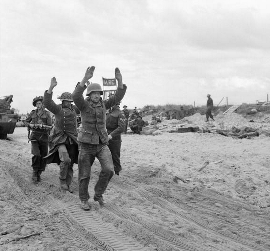 German POWs being escorted along one of the Gold area beaches. (June 6, 1944). Source: Imperial War Museums,  B 5257.