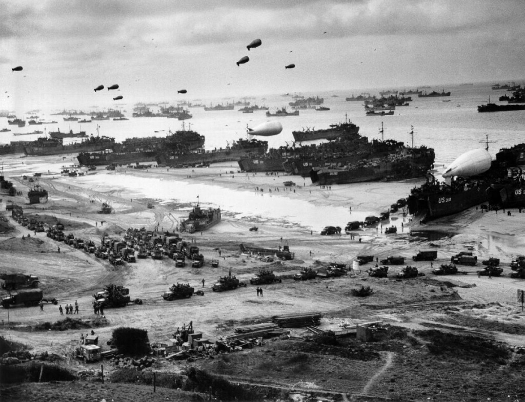 Landing ships putting cargo ashore on Omaha Beach. (Mid-June, 1944). Source: U.S. National Archives, # 26-G-2517.