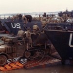 U.S. Army half-track antiaircraft machine gun vehicle backed into the well deck of a U.S. Navy LCT in prep for the Normandy invasion. (Late May or early June, 1944). Source: U.S. National Archives, # USA C-751.