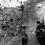 U.S. Army Rangers showing off the ladders they used to storm the cliffs of Pointe du Hoc, Normandy, France. (June 6, 1944). Source: U.S. National Archives, # 80-G-45716.