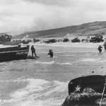 Scene on Omaha Beach in Normandy. LCI(L)-553 in background and a LCVP from APA Samuel Chase in left center. (June 6, 1944). Source: U.S. National Archives, # SC 189899.