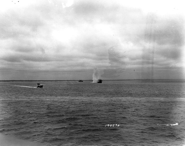 A German shell splashed near a LST off Utah Beach, Normandy. (June 6, 1944). Source: U.S. National Archives, # SC 190276, Photographer: Collier.