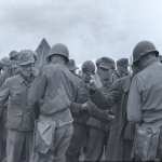 German prisoners being questioned and searched in encampments on Allied beachhead in France. Source: U.S. National Archives, # 80-G-231665.