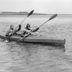 2 British Navy frogmen paddle 1 of the canoes; they were the underwater experts who blasted a hole in the Nazi's Atlantic Wall to enable invasion crafts to reach the Normandy beaches on D-Day. Source: Imperial War Museums, # A 30325.