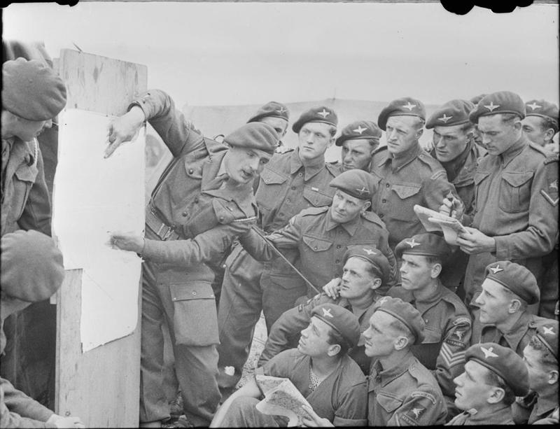 Men of 22nd Independent Parachute Company, 6th Airborne Division being briefed for the invasion. (June 4-5, 1944). Source: Imperial War Museums, # H 39089.
