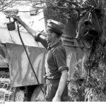 A German soldier spray painting a Jagdpanther tank destroyer for camouflage. France. (June 1944). Source: German Federal Archive, Bild 101I-721-0397-19.