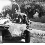 German troops transporting a wounded soldier with a SdKfz. 251 halftrack vehicle. Eastern Front. (June 21, 1944). Source: German Federal Archive, #Bild 101I-695-0401-16A.