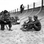 Canadians guarding captured German troops. Berniers Sur Mer, France. (June 6, 1944). Source: Library and Archives Canada.