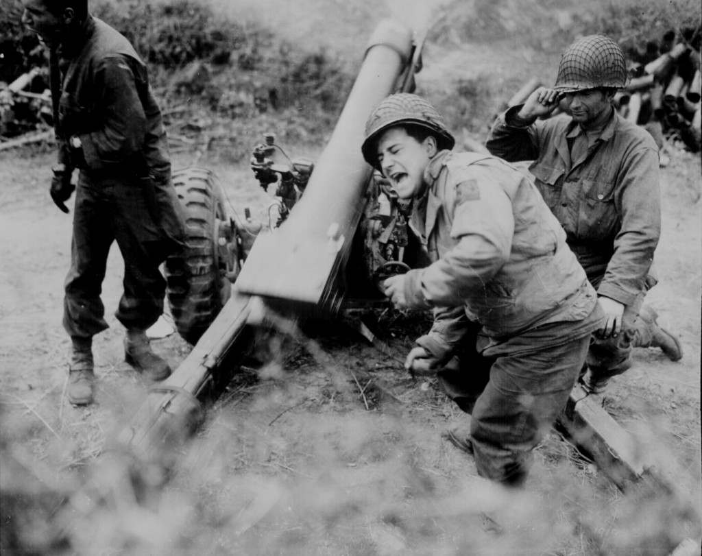 American howitzers shell German forces retreating near Carentan, France. (July 11, 1944). Source: U.S. National Archives, # 111-SC-191933.