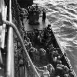 Men of the 386th Air Service Group go over the side of a transport ship into a landing craft which will take them ashore at Iwo Jima, Bonin Islands. (March 6, 1945). Source: Mark, www.7thfighter.com.