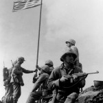 Marines in a forward position face Mount Suribachi the day before the patrols gain the top of the mountain and raise flags for all to see. (February 22, 1945). Source: Creative Commons.