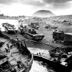 Smashed by Japanese mortar and shellfire, trapped by Iwo's treacherous black-ash sands, amtracs and other vehicles of war lay knocked out on the black sands of the volcanic fortress. (February-March 1945). Source: Robert M. Warren, Creative Commons.