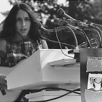 Joan Baez. A sign hanging near the microphones reads "We Shall Overcome." (Aug. 28, 1963). Source: U.S. National Archives #542017.