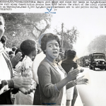 Girl sings and claps her hands as D.C. National Guard trucks roll along Constitution Ave.... (Aug. 28, 1963). Source: United Press International, New York World-Telegram & the Sun Newspaper Photograph Collection, Library of Congress #038.00.00.